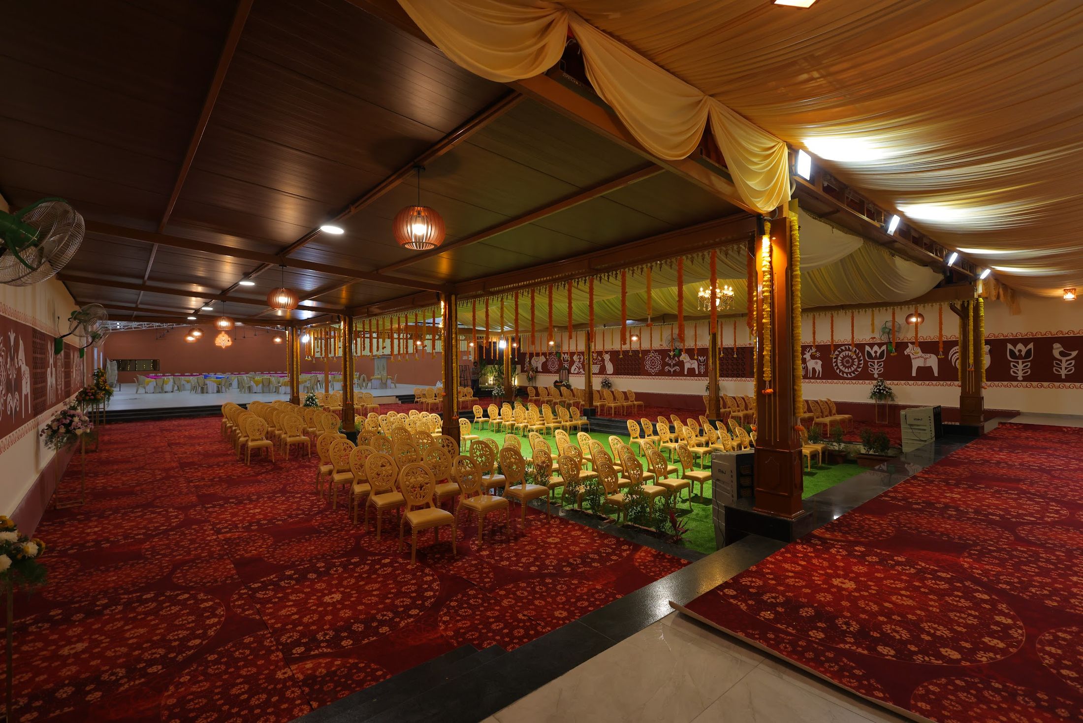 Warmly lit hall at an evening celebration at Akshaya Milan